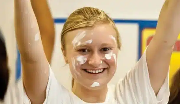 girl raising arms and smiling