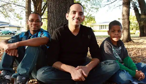man with children under tree